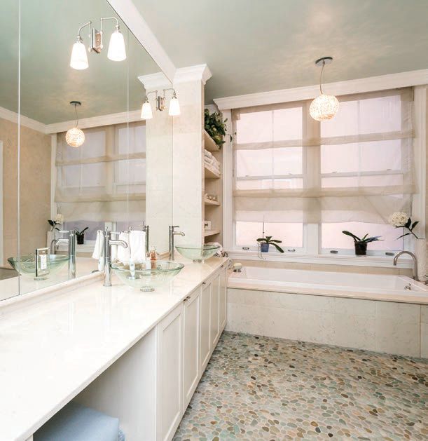 The master bathroom with tile flooring and white cabinetry PHOTO COURTESY OF ALLAN DOMB REAL ESTATE