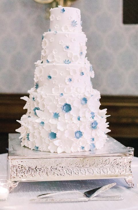 A five-tiered citrus cake with American buttercream frosting was created by The Union League. Photographed by Grace Ardor Photography