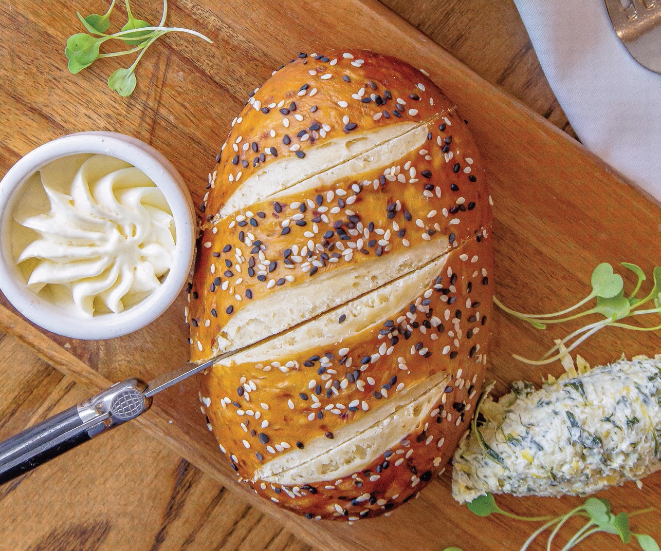 National Soft Pretzel Day will not be complete without a slice, or two, of White Dog Cafe’s housemade soft pretzel bread with spinach-artichoke spread and honey butter PHOTO BY: ALEXANDRA JADE TRINGALI