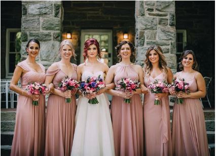 The bride with her bridesmaids in Azazie gowns Photographed by Meghan Burke